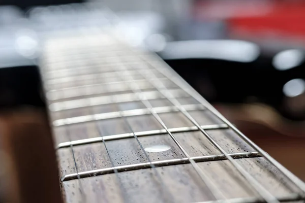 Neck with strings, close-up, on an old, classic acoustic guitar.