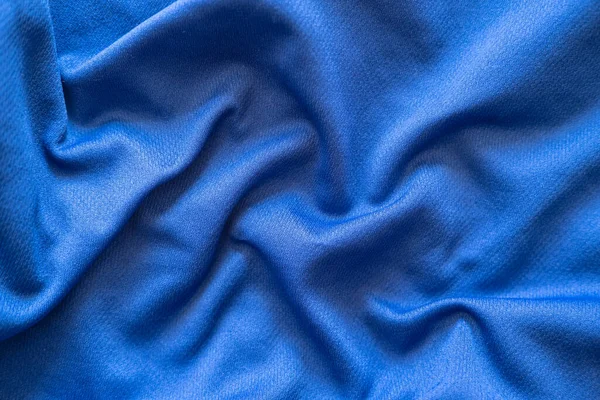 Crumpled blue synthetic fabric. Abstract empty background. Top view.