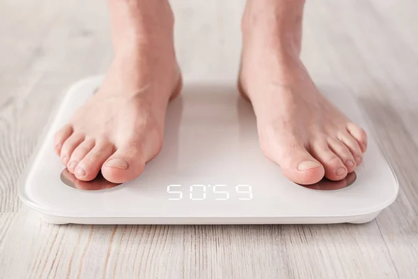 Bare feet stand on smart scale that makes bioelectric impedance analysis, BIA, body fat metric. — 스톡 사진