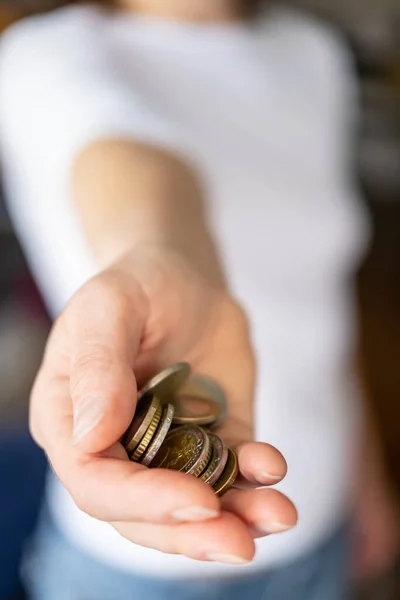 Kleiner Haufen Münzen in einer weiblichen Hand. Konzept von Krise und Sparen. — Stockfoto