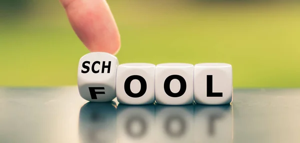 Don't be a fool and go to school. Hand turns a dice and changes — 스톡 사진