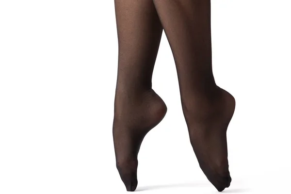 Vrouwelijke benen in zwarte kousen — Stockfoto