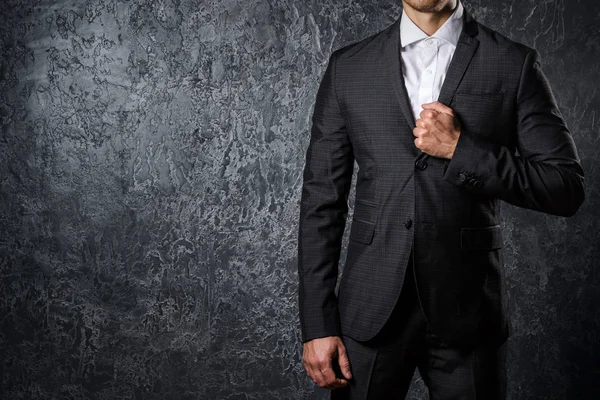 Man in suit against concrete wall — Stock Photo, Image