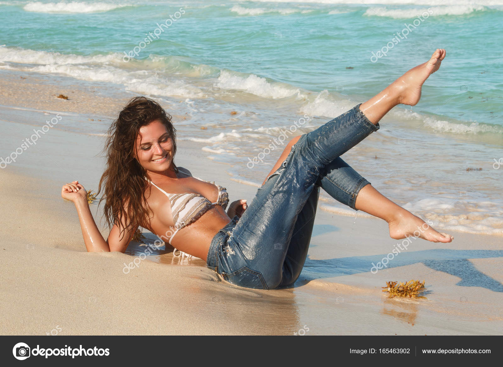 Woman in jeans on the beach Stock by ©AY_PHOTO 165463902