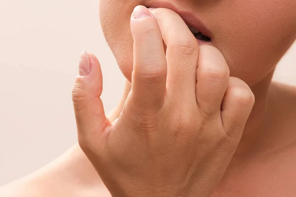 Woman bitting her fingers — Stock Photo, Image