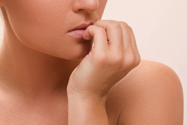 Woman bitting her fingers — Stock Photo, Image