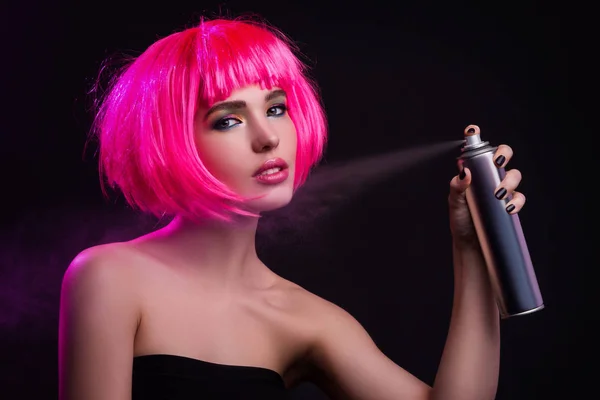 Woman with pink hair using hair spray — Stock Photo, Image