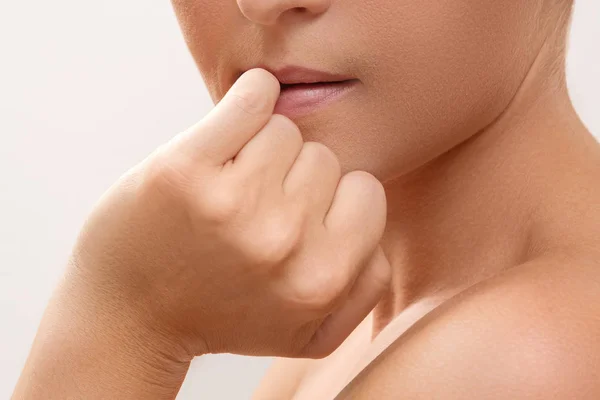 Woman bitting her finger — Stock Photo, Image