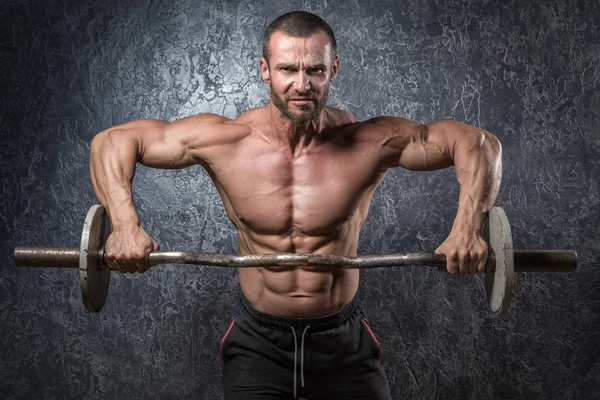 Bodybuilder with barbell — Stock Photo, Image