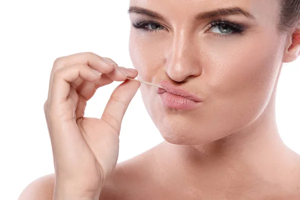 Serious woman with toothpick — Stock Photo, Image