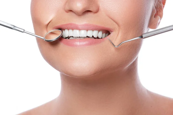 Smiling woman and dental tools — Stock Photo, Image