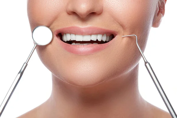 Smiling woman and dental tools — Stock Photo, Image