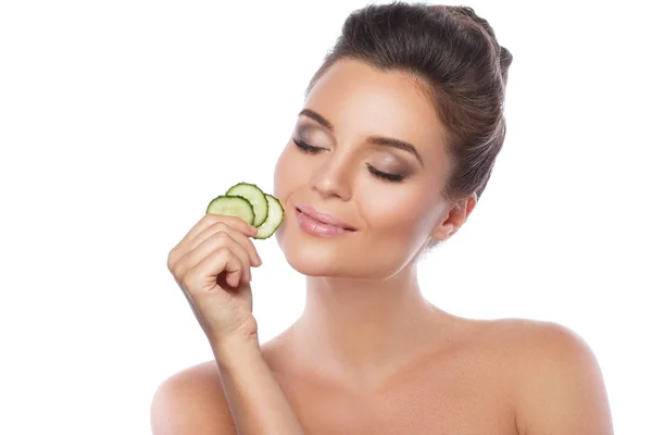 Young woman with cucumber slices — Stock Photo, Image