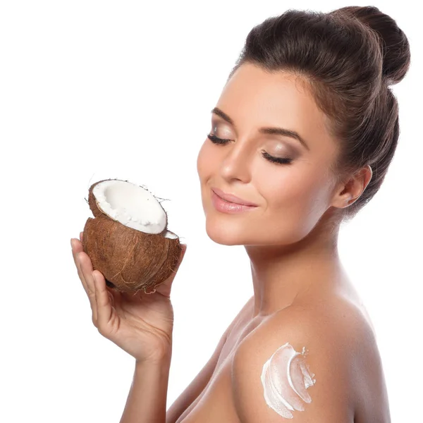 Woman with coconut and moisturizing cream — Stock Photo, Image