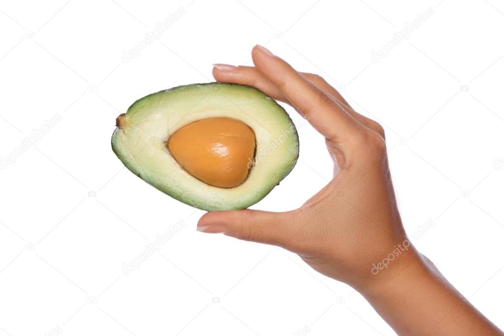 Female hand with fresh avocado  