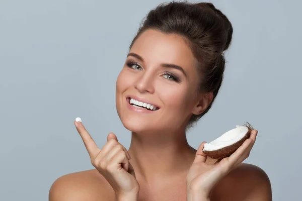 Woman with coconut and moisturizing cream — Stock Photo, Image