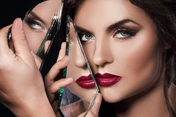 Mooie vrouw met scherven van spiegel — Stockfoto