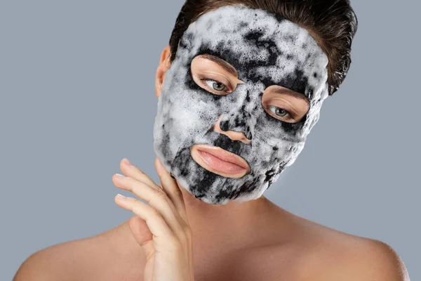 Young Woman Bubble Sheet Mask Her Face Gray Background — Stock Photo, Image