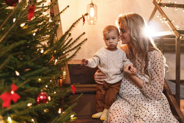 若い幸せな母親と彼女のかわいい息子はクリスマスや新年を祝っています — ストック写真