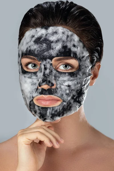 Young Woman Bubble Sheet Mask Her Face Gray Background — Stock Photo, Image