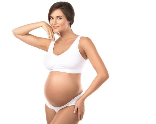 Genç Güzel Hamile Kadın Beyaz Arka Planda Çamaşırı Giyiyor — Stok fotoğraf