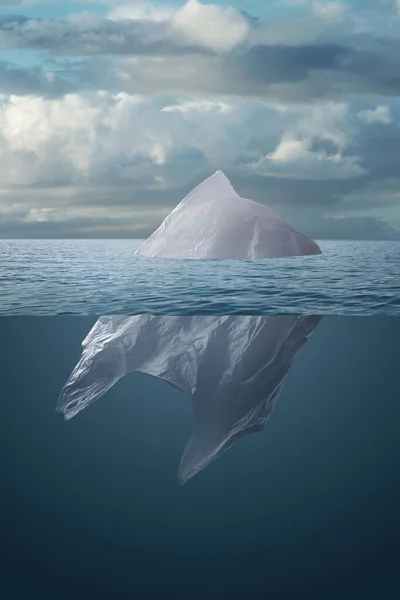 Plastic bag floating in the sea like an iceberg. Concept of earth pollution and global warming.