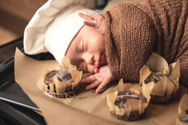 Cute Newborn Baby Wearing Chef Hat Lying Oven Tray Muffins — Stock Photo, Image