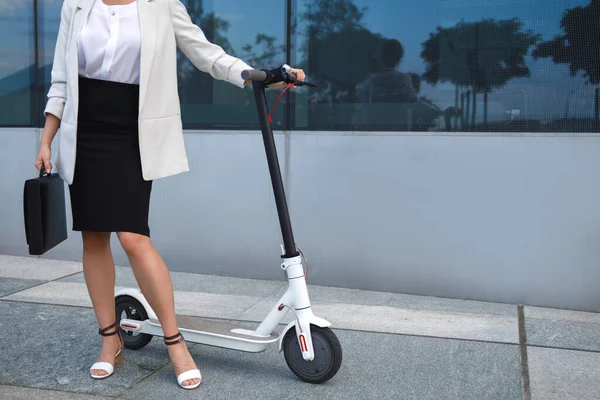 若くて美しい実業家が街の電動スクーターに乗る — ストック写真
