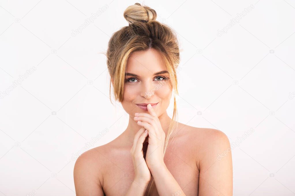 Portrait of young beautiful woman with perfect skin in studio