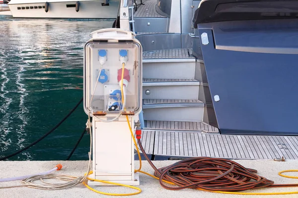 Electrical outlets for charging on boats in sea coast in Mediterranean. Charging station for boats and yachts. Ecology technology.