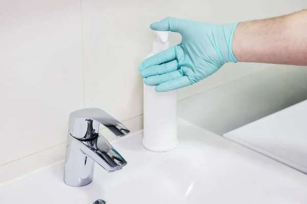 Washing hands with sanitizer man for covid-19 prevention in hospital. Cleaning to stop spreading corona virus. Health care and hygiene concept.
