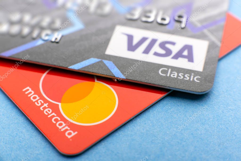 Bank cards visa and mastercard close-up, logos of payment systems, contactless payments worldwide, payment for goods on the Internet