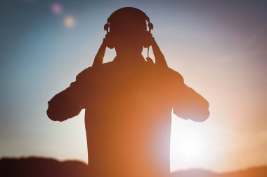 stylish bearded man in headphones listening to music clipart