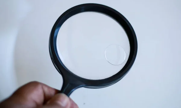 Use a magnifying glass to see small objects.