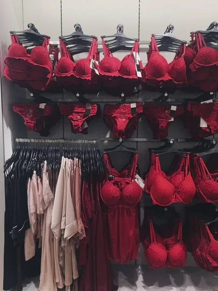 Red underwear on hangers in a store.