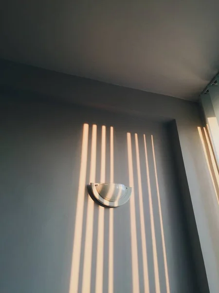 Lamp on the wall.  Sun rays