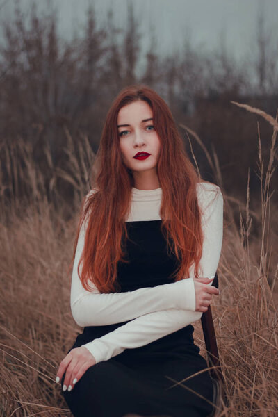Fashion portrait of a girl in a field