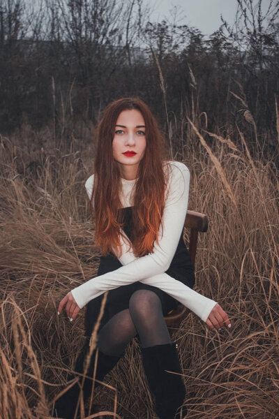 Fashion portrait of a girl in a field