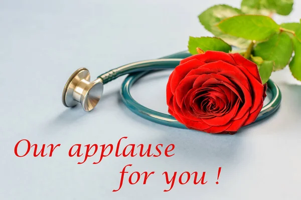 International happy nurses day. Congratulation for all the nurses and doctors. Our applause for you. Red rose and stethoscope on the blue background.