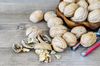 Kasede büyük ceviz yığını ve ahşap masada yakın plan. Sağlıklı meyve antioksidan ceviz. 