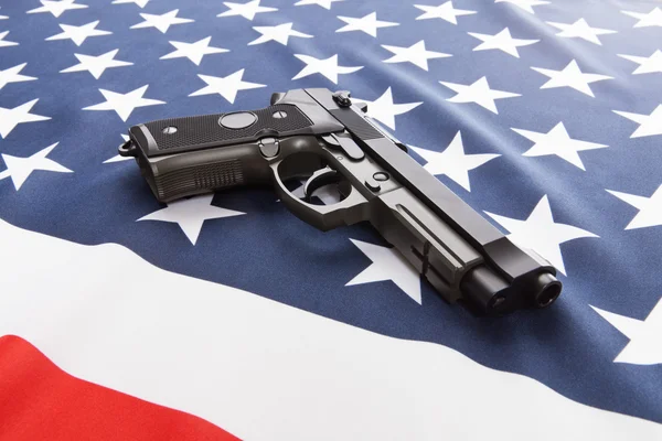 Ruffled silk flag with hand gun over it series - United States of America — Stock Photo, Image