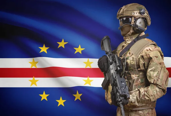 Soldat i hjälm holding kulspruta med flagga på bakgrunden-serien - Cabo Verde — Stockfoto