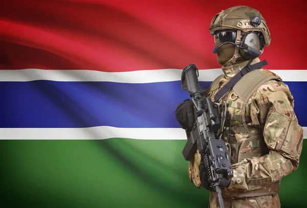 Soldier in helmet holding machine gun with flag on background series - Gambia — Stok Foto