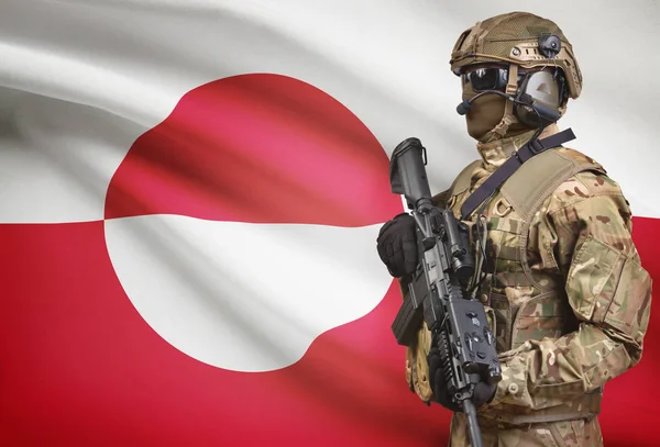 Soldier in helmet holding machine gun with flag on background series - Greenland — Stok Foto