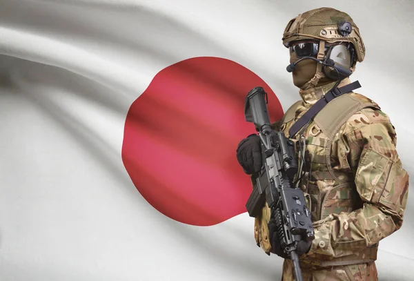 Soldier in helmet holding machine gun with flag on background series - Japan — Stok Foto