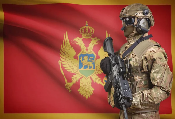 Soldier in helmet holding machine gun with flag on background series - Montenegro — Stok Foto