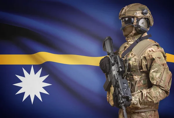 Soldier in helmet holding machine gun with flag on background series - Nauru — Stock Photo, Image