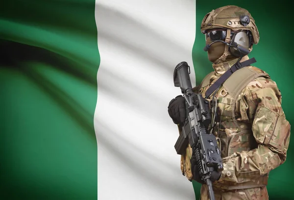 士兵在头盔持机枪与国旗背景系列-尼日利亚 — 图库照片