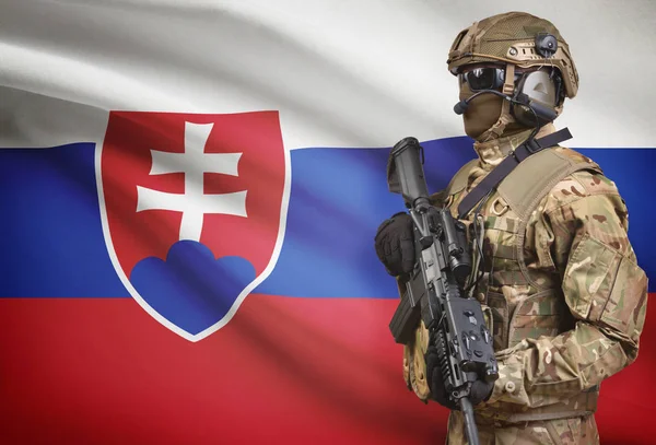 Soldier in helmet holding machine gun with flag on background series - Slovakia — Stock Photo, Image