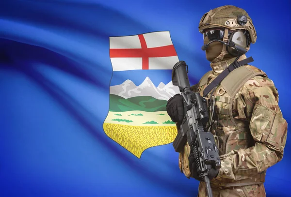 Soldaat in de helm bedrijf machinegeweer met Canadese provincie vlag op de achtergrond serie - Alberta — Stockfoto